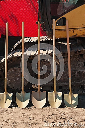 Front view of five shovels to be used in a ground breaking ceremony for a tropical, public park Stock Photo