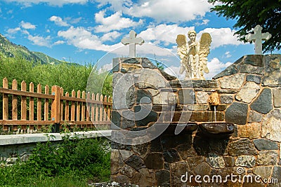 Front view of fountain in the church courtyard Stock Photo