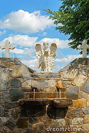Front view of fountain in the church courtyard Stock Photo