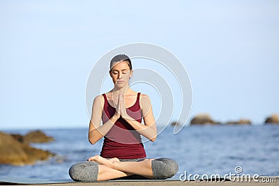 Yogi practicing yoga pose on the beach Stock Photo