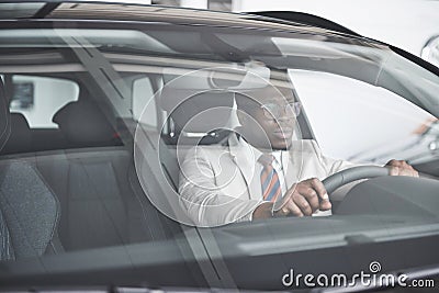 Front view of Handsome african elegant serious business man drives a car Stock Photo