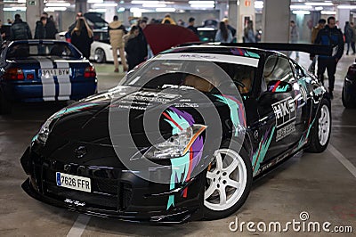 Front view of a Japanese racing car, the black Nissan 350Z tuned by HKS parked in a parking lot Editorial Stock Photo