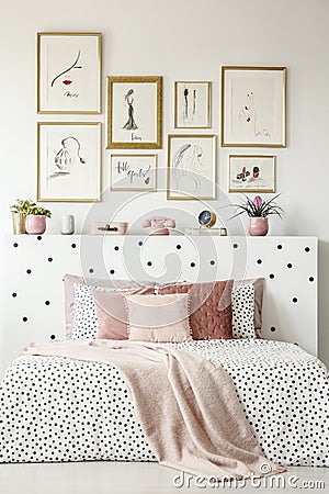 Front view of a king size bed with pink pillows, dotted sheets, Stock Photo