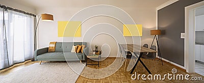 Front view living room with sofa with cushions, table with chairs and door open to the kitchen Stock Photo