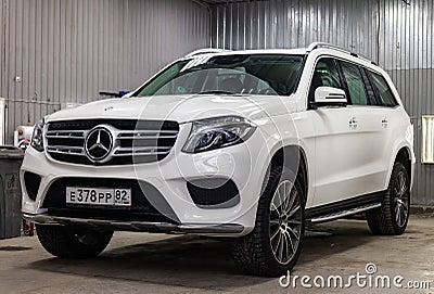 Front view of luxury very expensive new white Mercedes-Benz GLS 350d car stands in the washing box waiting for repair in auto Editorial Stock Photo