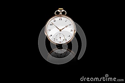 Front view of old antique mechanical golden steel pocket watch isolated on black background. Stock Photo