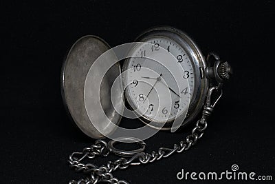 Front view of a pocketwatch on a black background Stock Photo