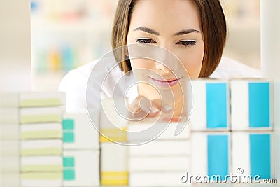 Relaxed pharmacist searching medicines in a pharmacy Stock Photo