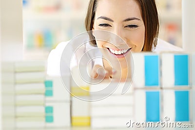 Happy pharmacist searching medicine in a pharmacy Stock Photo