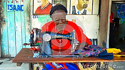Seamstress making clothes on an old Singer Sewing Machine Editorial Stock Photo