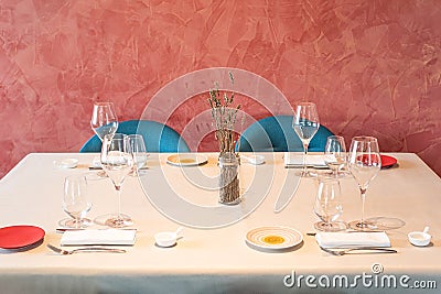 Front view of various glasses and cutlery ready to use. Stock Photo