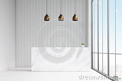 Front view of a white reception desk standing in an office hall. There are three lamps above it and a panoramic window. Stock Photo