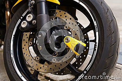 Front wheel of a Yamaha motorcycle with logo. Editorial Stock Photo