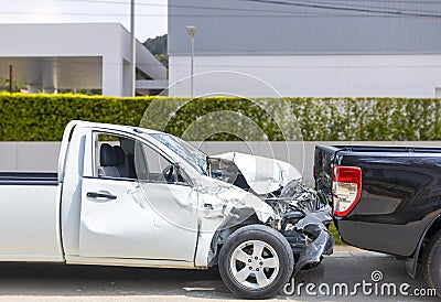 Front White color pack up car crash with back side black color car get damaged by accident on city street Stock Photo