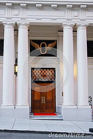 Front wooden door of classical building with four pillars Stock Photo
