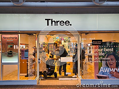 The frontage of a branch of mobile phone and broadband telecoms provider Three Editorial Stock Photo