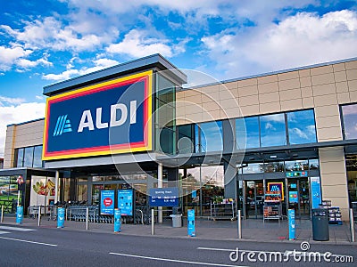 The frontage and brand logo of a branch of German discount retailer Aldi, taken in a local retail park in the UK Editorial Stock Photo