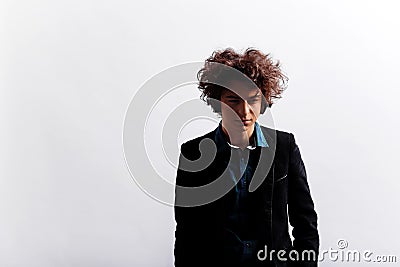 Portrait of frowning, sad young man with awesome hairdo, with headphones, looking pensive, isolated on white background. Stock Photo