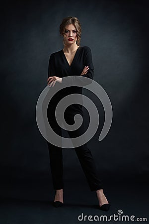 Frontview of confident woman wearing black suit. Stock Photo