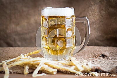 The frost-coated mug with cold beer. Stock Photo