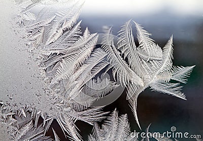 Frost draws ice background patterns on a windowpane Stock Photo