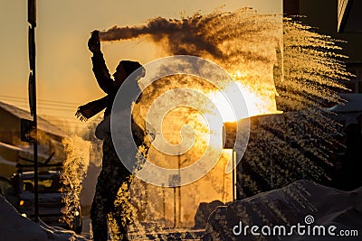 Frost effect hot water freezes man pours boiling water Stock Photo