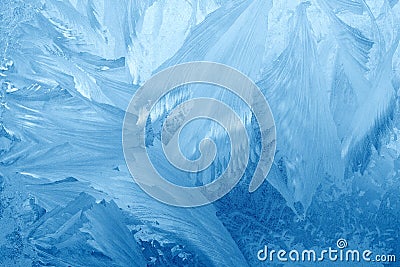 Frost patterns on window glass in winter. Frosted Glass Texture. Blue Stock Photo