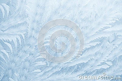 Frost patterns on window glass in winter season. Frosted Glass Texture. Blue background Stock Photo