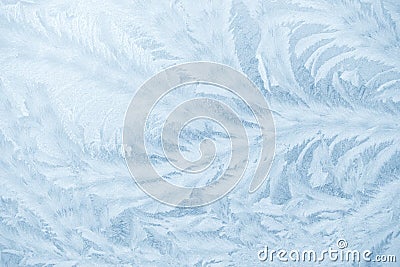 Frost patterns on window glass in winter season. Frosted Glass Texture. Blue background Stock Photo