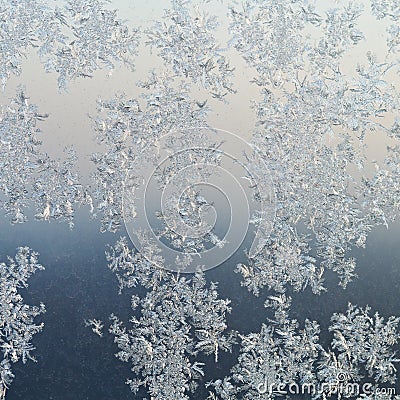 Frost patterns on windowpane at winter dawn Stock Photo