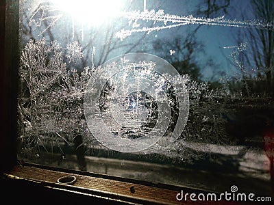 Frost on Window Pane with Sunlight Shining Stock Photo