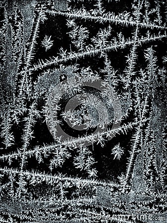 Frostwork pattern ice crystals on black background. Dark surface with ice structure makes to overlay or add a frost effect Stock Photo