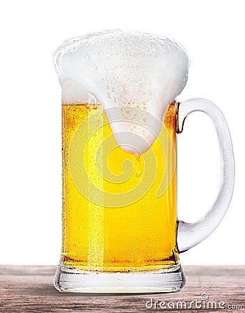 Frosty beer with foam isolated on wooden table Stock Photo