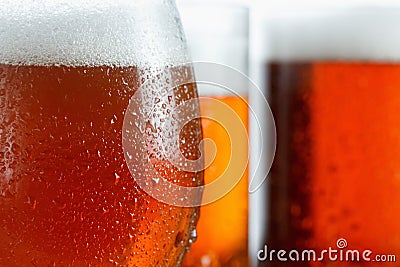 Frosty glasses of cool beer foam, covered with drops, closeup Stock Photo