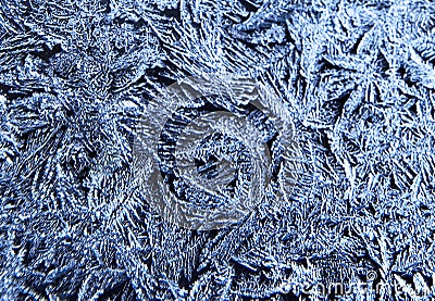 Frosty natural pattern on the window.Frozen patterns on the glass.Winter ice embroidered lace background.Frosted icy texture. Stock Photo