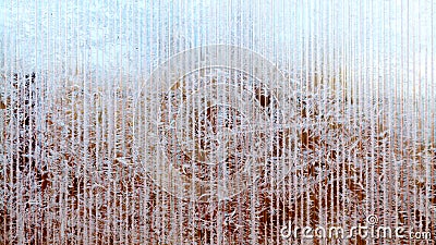 Frosty pattern of hoarfrost and snowflakes on striped glass, winter or Christmas background, texture Stock Photo