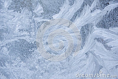 Frosty patterns on the window, close-up. Beautiful frosty background, from patterns on the window. Frozen windows. Stock Photo