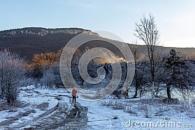 Frosty winter morning in nature, warm morning light on the background of snow, shrubs and trees in patterns of frost. Stock Photo