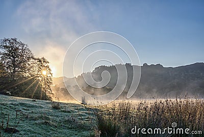 A frosty winter sunrise next to Rydal Water in the Lake District Stock Photo
