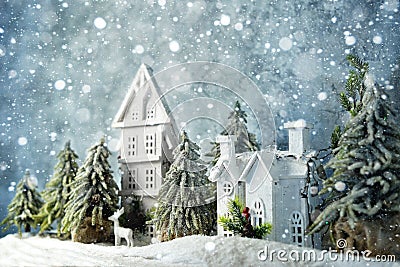 Frosty winter wonderland forest with snowfall, houses and trees. Christmas greetings concept Stock Photo