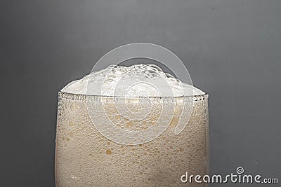 Froth of craft beer closeup on wooden background.The concept of food Stock Photo