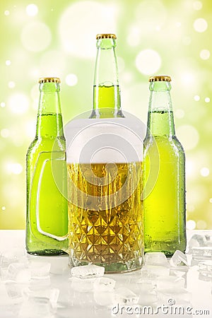 Frothy beer in the glass and bottles Stock Photo