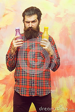 Frown bearded man holding two plastic bottles Stock Photo