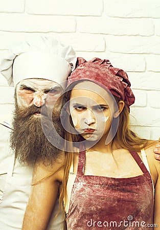 Frown cook and pretty girl Stock Photo