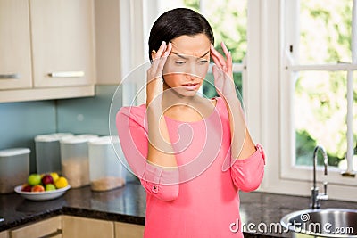 Frowning brunette with hands on face Stock Photo