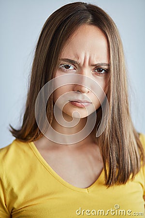 Frowning serious girl isn`t satisfied with her skin Stock Photo