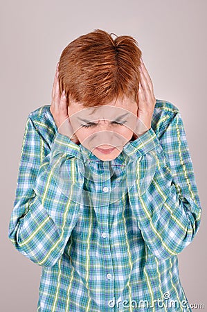 Frowning woman covering her ears with hands Stock Photo