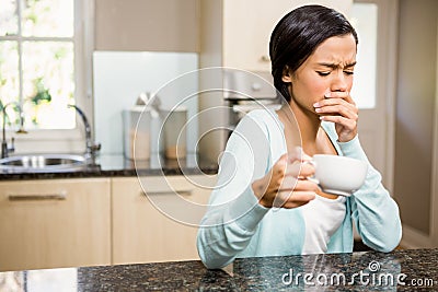 Frowning woman with toothache holding cup Stock Photo