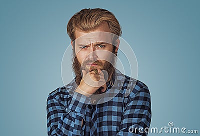 Frowning young man thinking expressing doubts and concerns Stock Photo