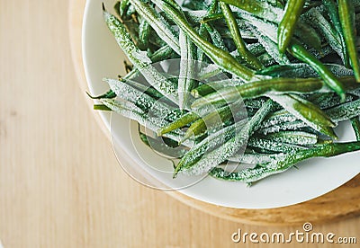 Frozen asparagus beans on a white plate. Vegetarian dish for improvement of health Stock Photo